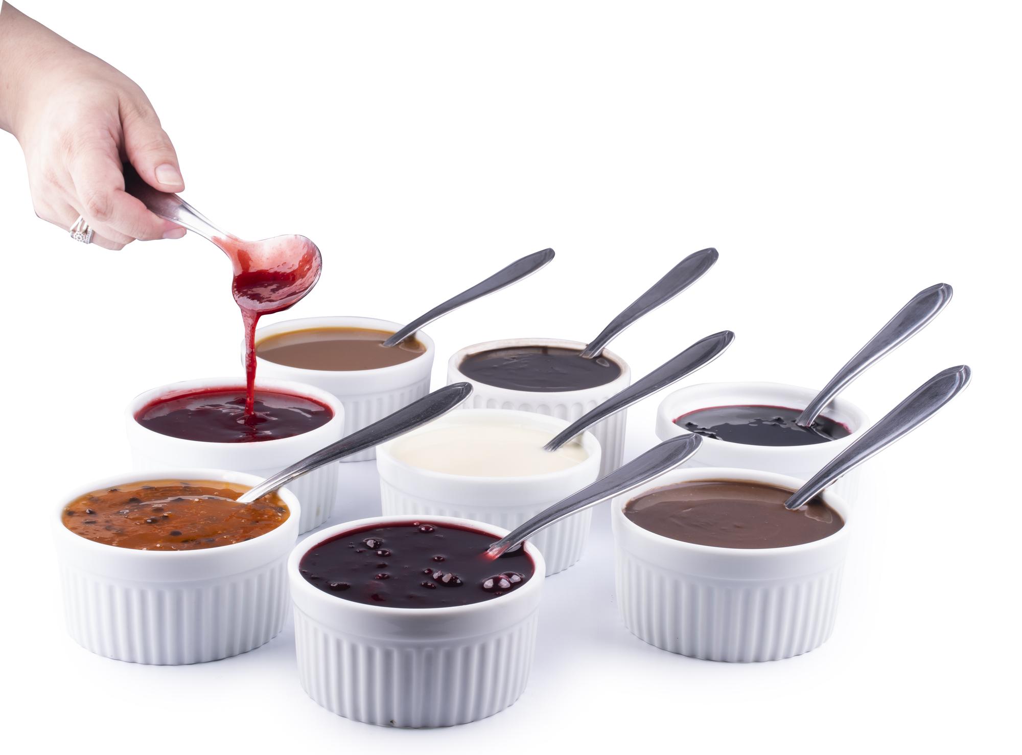 team tasting sauces in kitchen